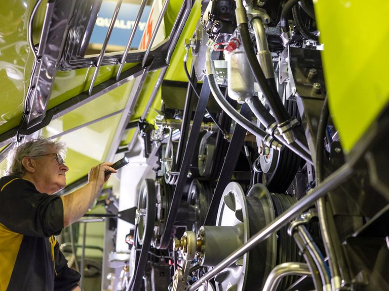 working-areas-image-quality Man with flashlight in hand checks machine