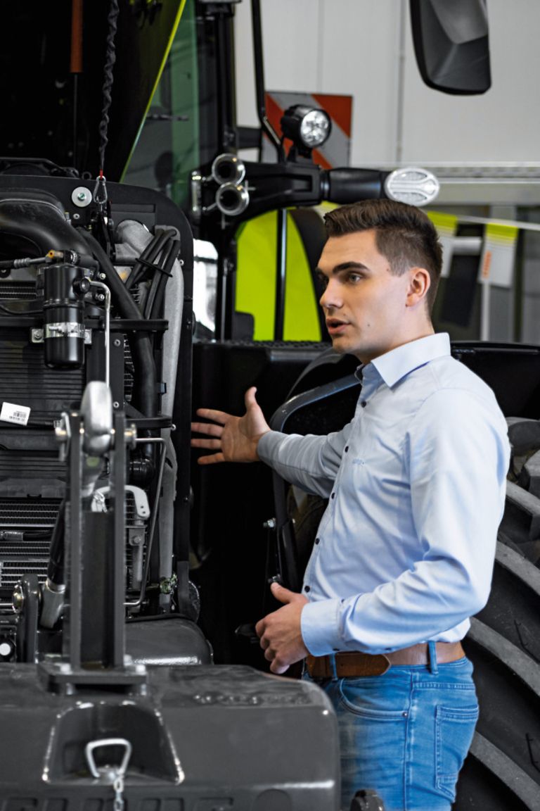 working-areas-stage-pic Colleagues standing in front of tractor with bonnet open